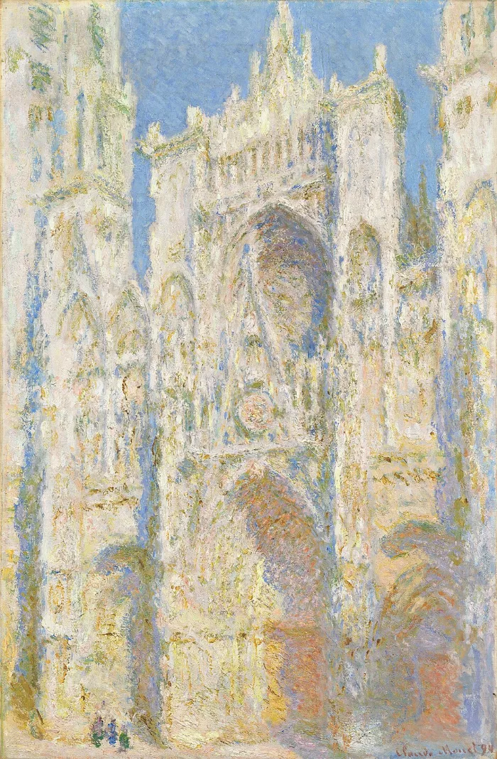 The stone front of a cathedral, painted almost entirely in gold, cream and blue. The building is grey; the picture is not.