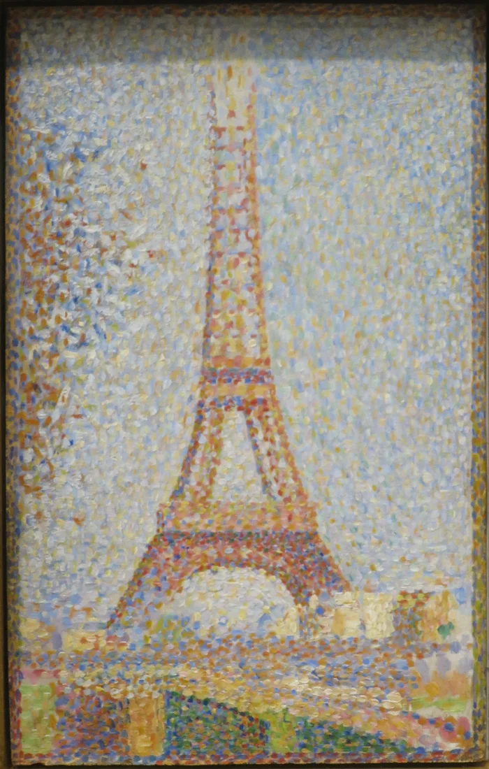 The Eiffel Tower, still half-built and painted orange-red against a pale sky. Tower, sky and ground are all made of separate dots.