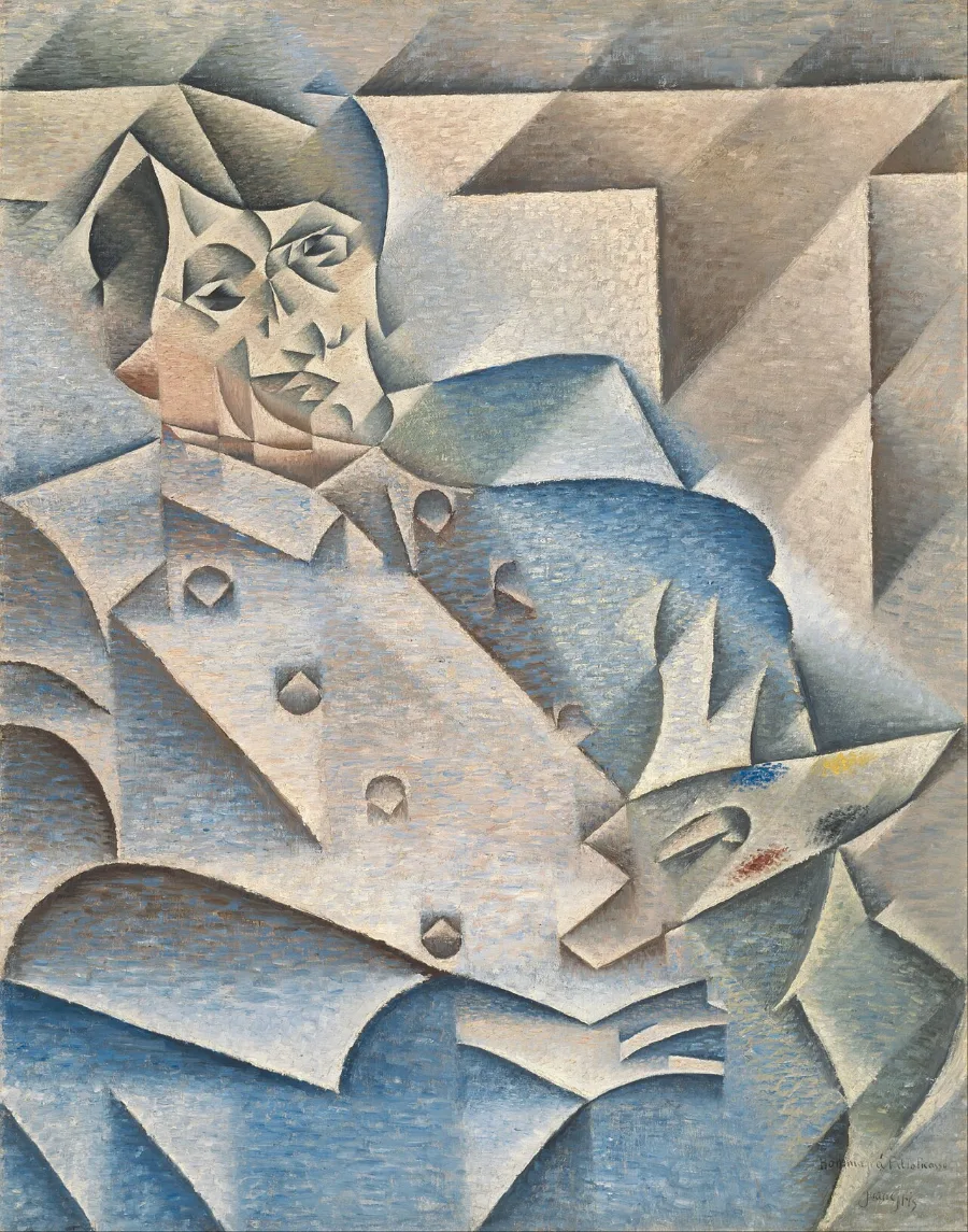 Picasso sits holding a palette, painted in blue and grey facets that tilt in different directions. His face is unmistakable, and the light seems to arrive from several places at once.