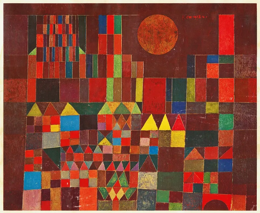 A wall of small coloured rectangles in reds, greens and blues, with a round orange sun sitting among them. A castle if you decide it is one, and a mosaic of colour if you do not.