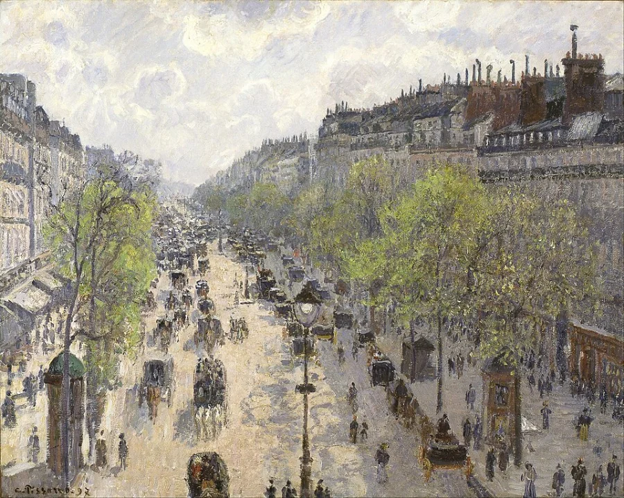 A wide Paris boulevard seen from a window above it, full of carriages and small figures, with bare spring trees running down both sides.
