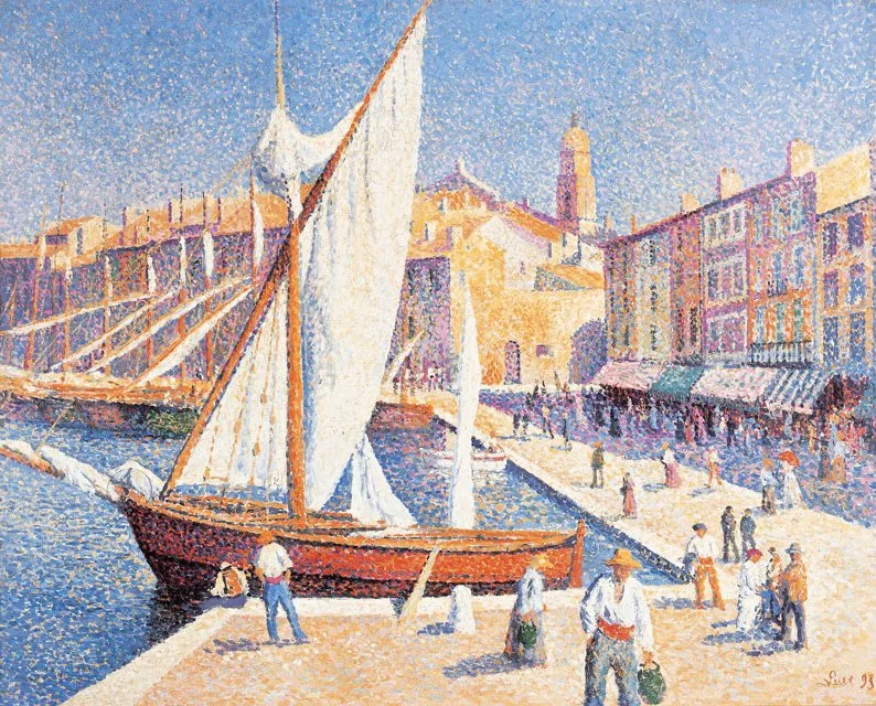 A tall white sail in a bright Mediterranean harbour, with people walking along the quay and awnings over the shopfronts behind them.