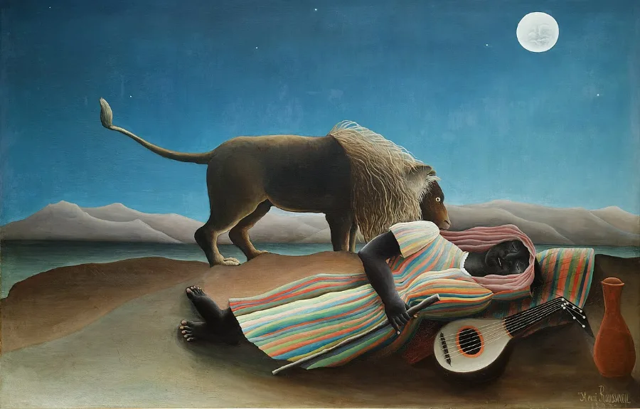 A lion stands over a sleeping figure in a striped robe on flat sand under a full moon. A mandolin and a jar lie beside them, and nobody seems worried.